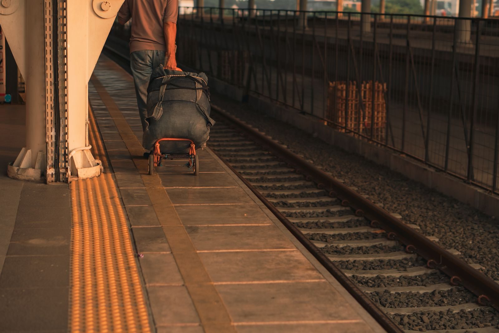 Traveler with luggage on a station platform