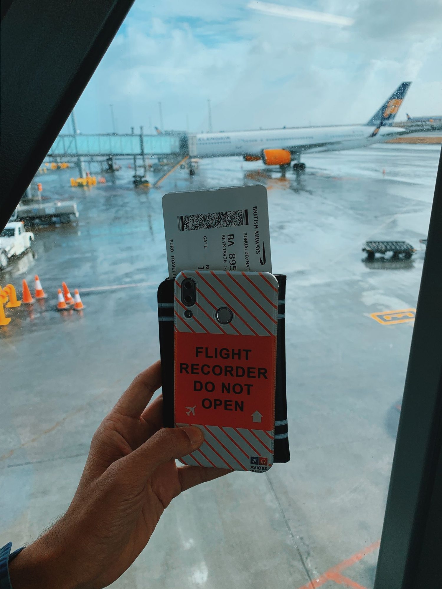 Smartphone and paper travel documents at an airport