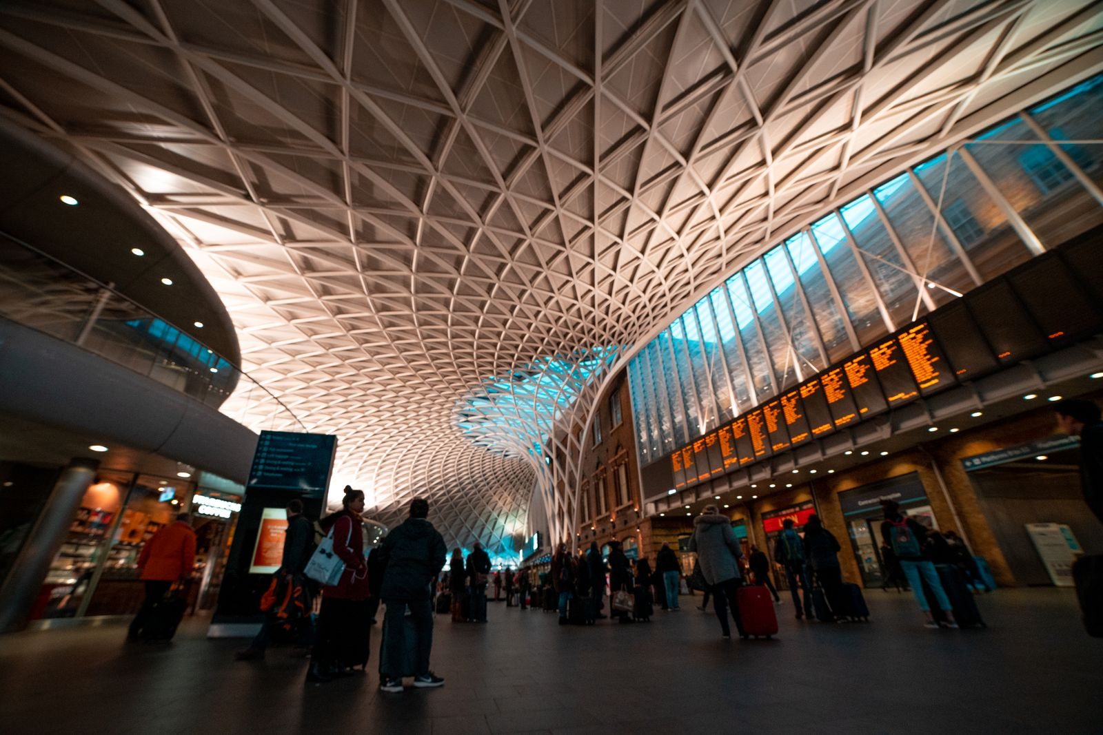 Travelers inside a large railway concourse